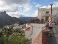 Tejeda, Gran Canaria, Canary Islands, Spain December 15, 2020: Young woman standing in front of town hall, admiring view of