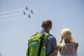 An unidentified men and women Viewing t6 texan in aerial demonstration In israeli Independence Day