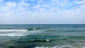 Tel Aviv. Blue sky. White clouds. Birch water. The sun. The waves. Surfing. Royalty Free Stock Photo