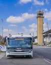 Airport shuttle bus, in background Air traffic control Tower, Ben Gurion Airport, Tel Aviv, Israel