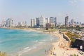 Tel Aviv, Israel, August 12th, 2018: Lots of tourists and locals are swimming at blue Mediterranean sea and spending