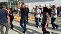 Unidentified citizens dancing traditional Israeli dances on Tel Aviv Promenade