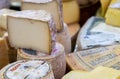 Large assortment of different cheeses for sale at cheeses store of farmers market