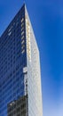 TEL AVIV/ISRAEL - July 2019: Modern acute angle glass modern skyscraper office building in Tel Aviv, Israel. Day view on blue sky