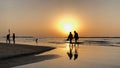 Tel-aviv, Israel - March 2018: People walking along Jerusalem Beach at sunset in Tel-aviv, Israel Royalty Free Stock Photo