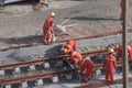 Tel Aviv, Israel - May 20 2021: Construction Workers with Orange overalls. Light rail tracks. blue collar worker