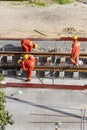 Tel Aviv, Israel - May 20 2021: Construction Workers with Orange overalls. Light rail tracks. blue collar worker