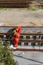 Tel Aviv, Israel - May 20 2021: Construction Workers with Orange overalls. Light rail tracks. blue collar worker