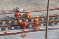 Tel Aviv, Israel - May 20 2021: Construction Workers with Orange overalls. Light rail tracks. blue collar worker