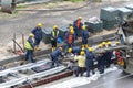 Tel Aviv, Israel - May 20 2021: Construction Workers working in the rain. Light rail tracks. blue collar worker. Concept