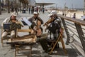 Tel Aviv, Israel - 2019-04-27 - String trio composed of elderly men play on the beach boardwalk Royalty Free Stock Photo