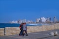 Tel Aviv, Israel -    Three friends walk along a promenade beside the Mediterranean Sea Royalty Free Stock Photo