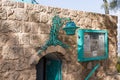 A decorative metal lamp hangs above the entrance to the Aladdin restaurant on the waterfront in old Yafo in Israel