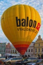 Big yellow hot air balloon ready to take off from the main square of the city Telc. Royalty Free Stock Photo