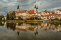 View of the cityscape of Telc and reflection in water