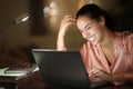 Tele worker in the night laughing checking laptop Royalty Free Stock Photo