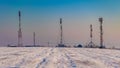 telecom relay on a snowy field seen in the winter Royalty Free Stock Photo
