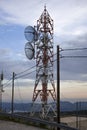 A telecom tower with two parabolic antennas with pylon carrying cables. It uses a parabolic reflector, a curved surface with the c Royalty Free Stock Photo