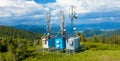 Aerial view of telecom towers and Digital and analog Television transmission tower on top of mountain.