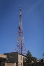 A telecomm tower phone network on hill with blue sky