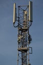 A Telecommunication antenna mast with blue sky background, France