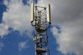 A Telecommunication antenna mast with a slightly cloudy background