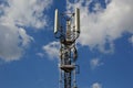 A Telecommunication antenna mast with a slightly cloudy background