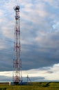 Telecommunication antenna tower on a background of clouds in the