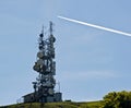 Telecommunication antennas and jet trail Royalty Free Stock Photo