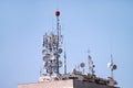 Telecommunication base stations network repeaters on the roof of building. The cellular communication aerial on city building roof Royalty Free Stock Photo