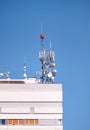 Telecommunication base stations network repeaters on the roof of building. The cellular communication aerial on city building roof Royalty Free Stock Photo