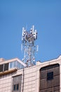 Telecommunication base stations network repeaters on the roof of building. The cellular communication aerial on city building roof Royalty Free Stock Photo