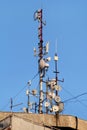 Telecommunication base stations network repeaters on the roof of building. The cellular communication aerial on city building roof Royalty Free Stock Photo