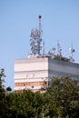 Telecommunication base stations network repeaters on the roof of building. The cellular communication aerial on city building roof Royalty Free Stock Photo