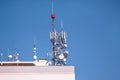 Telecommunication base stations network repeaters on the roof of building. The cellular communication aerial on city building roof Royalty Free Stock Photo