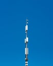 Telecommunication cell tower antenna against blue sky background. Wireless communication and modern mobile internet. Royalty Free Stock Photo