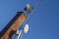 Telecommunication devices on a brick chimney Royalty Free Stock Photo