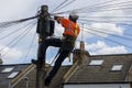 Telecommunication engineer at the top of a telephone pole.