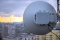 Telecommunication equipment for wireless data transmission is a close-up.Powerful round antenna is on the roof of the building.