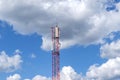 Telecommunication metal tower against blue bright sunny sky. Equipment for cellular communications. Transmitting and rec Royalty Free Stock Photo