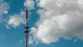 Telecommunication radio tower on the vast blue sky background. White clouds on sky Royalty Free Stock Photo