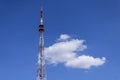 Telecommunication radio tower on the vast blue sky background. White clouds on sky Royalty Free Stock Photo