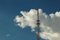 Telecommunication radio tower on the vast blue sky background. White clouds on sky Royalty Free Stock Photo