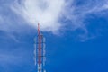 Telecommunication radio wave signal tower red and white with cloudy. Steel truss of transmission signal antenna with blue sky. Royalty Free Stock Photo