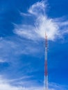 Telecommunication radio wave signal tower red and white with cloudy. Steel truss of transmission signal antenna with blue sky. Royalty Free Stock Photo