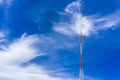 Telecommunication radio wave signal tower red and white with cloudy. Steel truss of transmission signal antenna with blue sky. Royalty Free Stock Photo