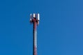 Big metal tower with telecommunication antennas for mobile phone and and copy space on blue sky Royalty Free Stock Photo