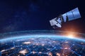 Telecommunication satellite providing global internet network and high speed data communication above Europe. Satellite in space, Royalty Free Stock Photo