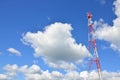 Telecommunication tower against the blue sky with clouds, cell antenna, transmitter. Telecom TV radio mobile tower