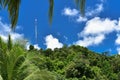 5G Telecommunication tower with antenna in the middle of the jungle with blue sky in the background. Royalty Free Stock Photo